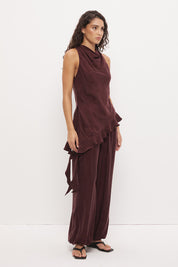 Sleeveless longline top in brushed cupro satin with narrow cowl neckline and asymmetric spiral flounce hem