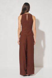 Sleeveless textured woven top with crew neckline, ladder trim detail, twisted waist sash, and side seam splits