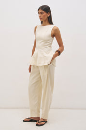 Sleeveless cotton twill top with fit and flare silhouette, open back tie detail and circle cut hem