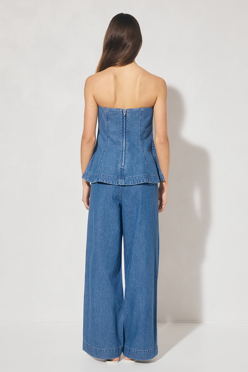 Strapless denim fit-and-flare top with cornelli piping, princess seams, flared circle-cut hem, and centre-back zipper