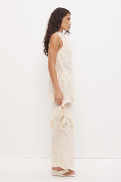 Sleeveless longline top in brushed cupro satin with narrow cowl neckline and asymmetric spiral flounce hem