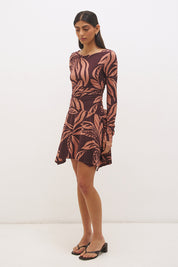 Printed handkerchief hem mini dress with boat neckline, ruched long sleeves, gathered bodice, and hi-lo draped skirt in stretch modal jersey