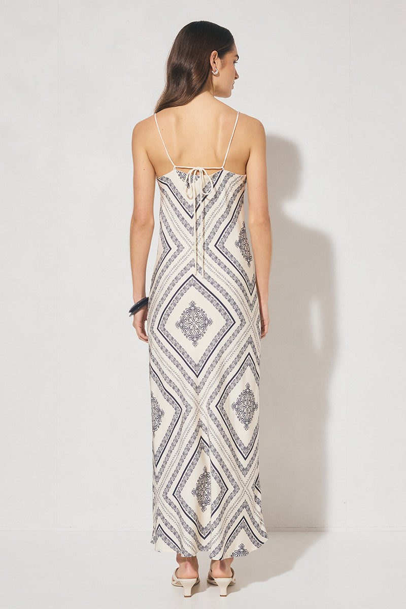 Bias cut maxi slip dress with handcrafted placement print, straight neckline, handkerchief front panel, and adjustable multiwear straps