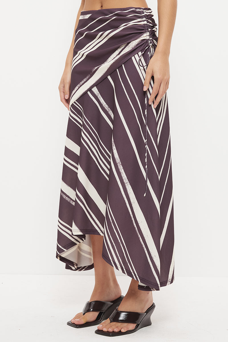 Mid-rise midi skirt with deep asymmetrical waist yoke, drawcord ruching and draped hi-lo hem in exclusive handcrafted print