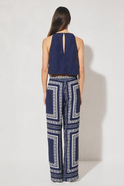 Sleeveless bias top with handcrafted placement print, cowled neckline, handkerchief hemline, and centre-back keyhole