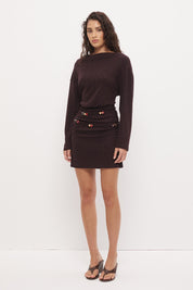 Oversized jersey mini dress with boat neckline, beaded asymmetrical waist straps, cinched silhouette, and fitted mini skirt