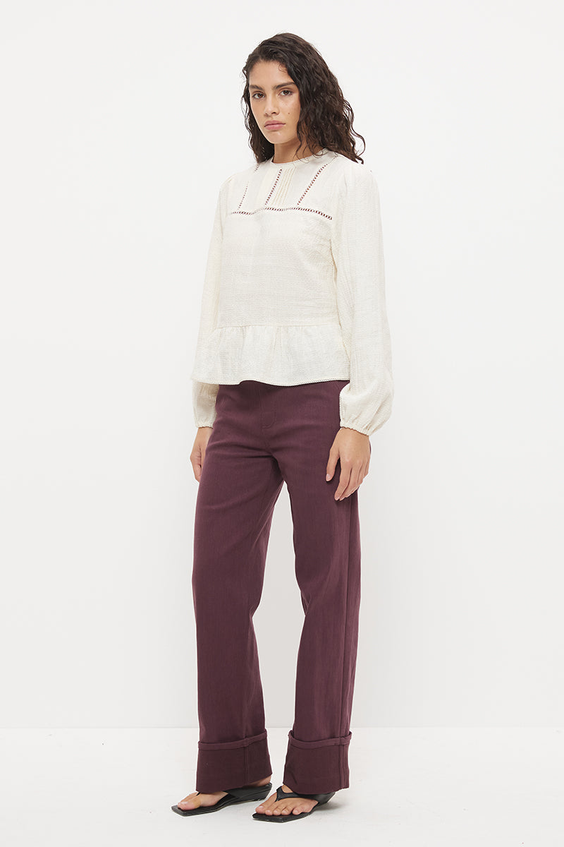 Long sleeve seersucker blouse with scalloped round neckline, balloon sleeves and lace-trimmed peplum hem