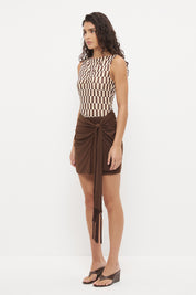 Bodycon mini dress with printed bodice, contrast sarong skirt and macrame tassel tie