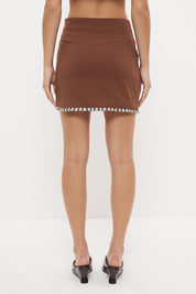 High waisted mini skirt in textured stretch cotton with two-tone fringed hem