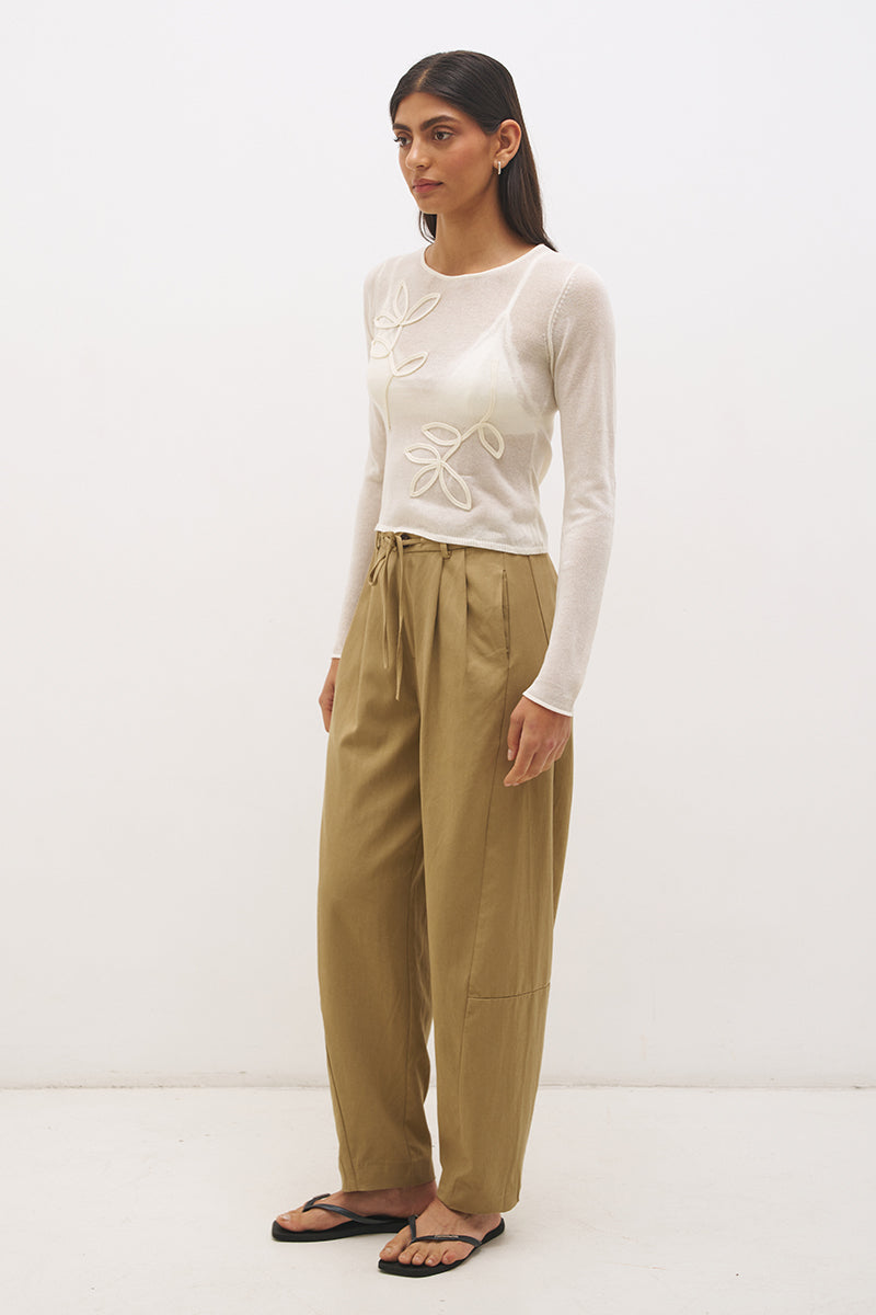 Semi sheer knitted long sleeve top with floral appliqué, jewel neckline and skimming fit