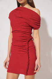 One-shoulder textured jersey mini dress with skimming fit, multi-wear draped neckline, gathered capped sleeve, cascading gathers, contrast frill hip panel, and figure-hugging mini skirt