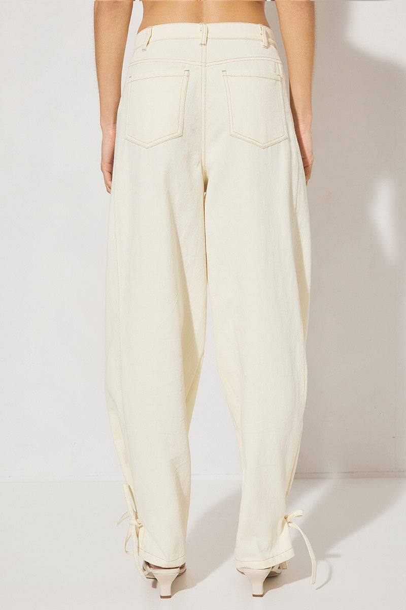 Hi-rise denim waisted pants with straight leg, side panel ties, back patch pockets, angled yoke, side seam pockets, and contrast topstitching