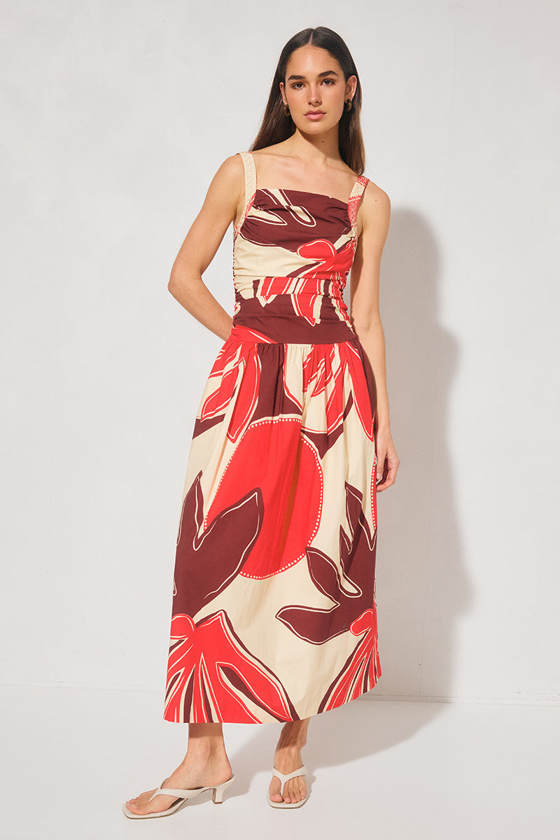 Handcrafted print strappy maxi dress with ruched bodice, dropped waist, gathered skirt, adjustable straps, and apron neckline