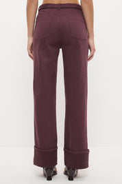 Mid-rise straight leg denim jeans with wide cuff hem and contrast buckle belt