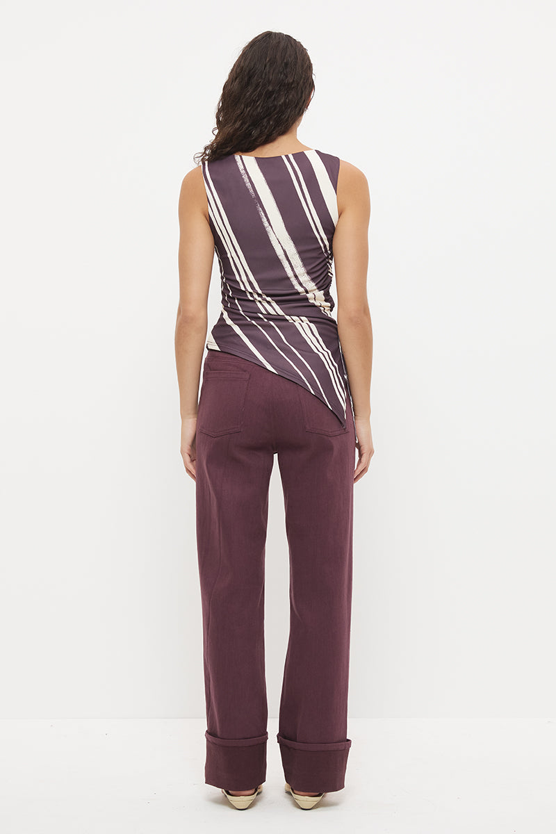 Sleeveless longline top with asymmetrical hemline, boat neckline and cascading waist ruching in exclusive handcrafted print