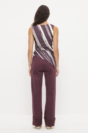 Sleeveless longline top with asymmetrical hemline, boat neckline and cascading waist ruching in exclusive handcrafted print