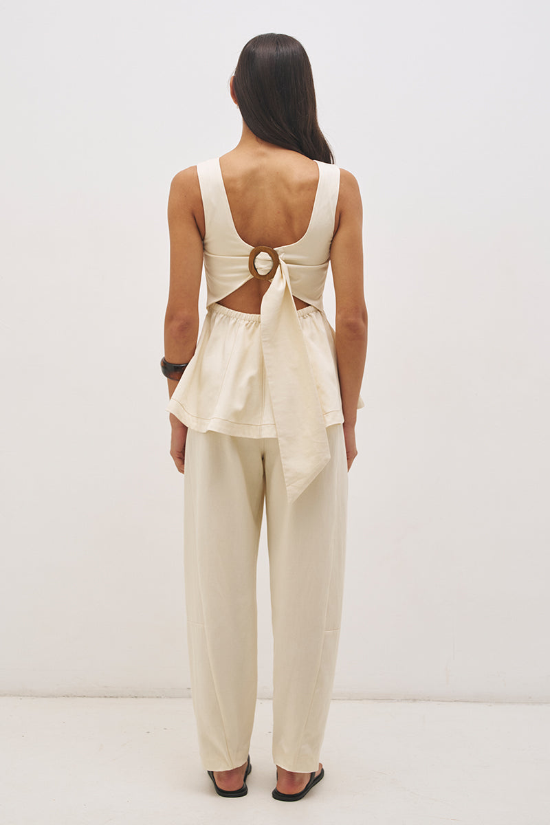Sleeveless cotton twill top with fit and flare silhouette, open back tie detail and circle cut hem