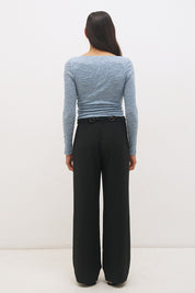 Woman wearing a textured lace long sleeve top with a boat neckline, semi-sheer sleeves, and centre front chest ruching in a skimming fit.