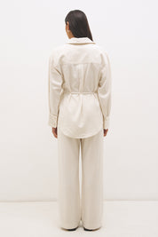 Woman wearing a satin-backed linen blend longline tunic with V neckline, curved hem, relaxed fit, and removable waist tie