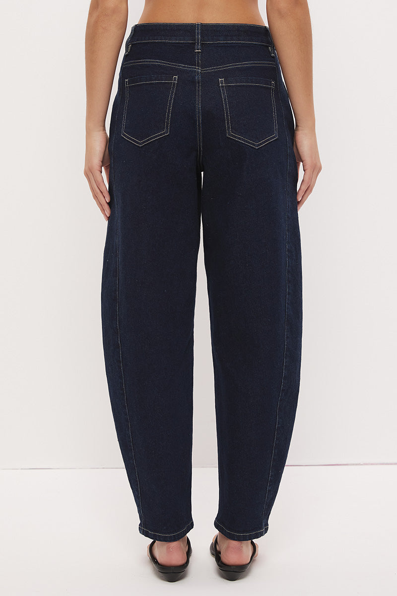 High-rise stretch denim barrel leg jeans with curved silhouette, contrast topstitching, and panelled construction