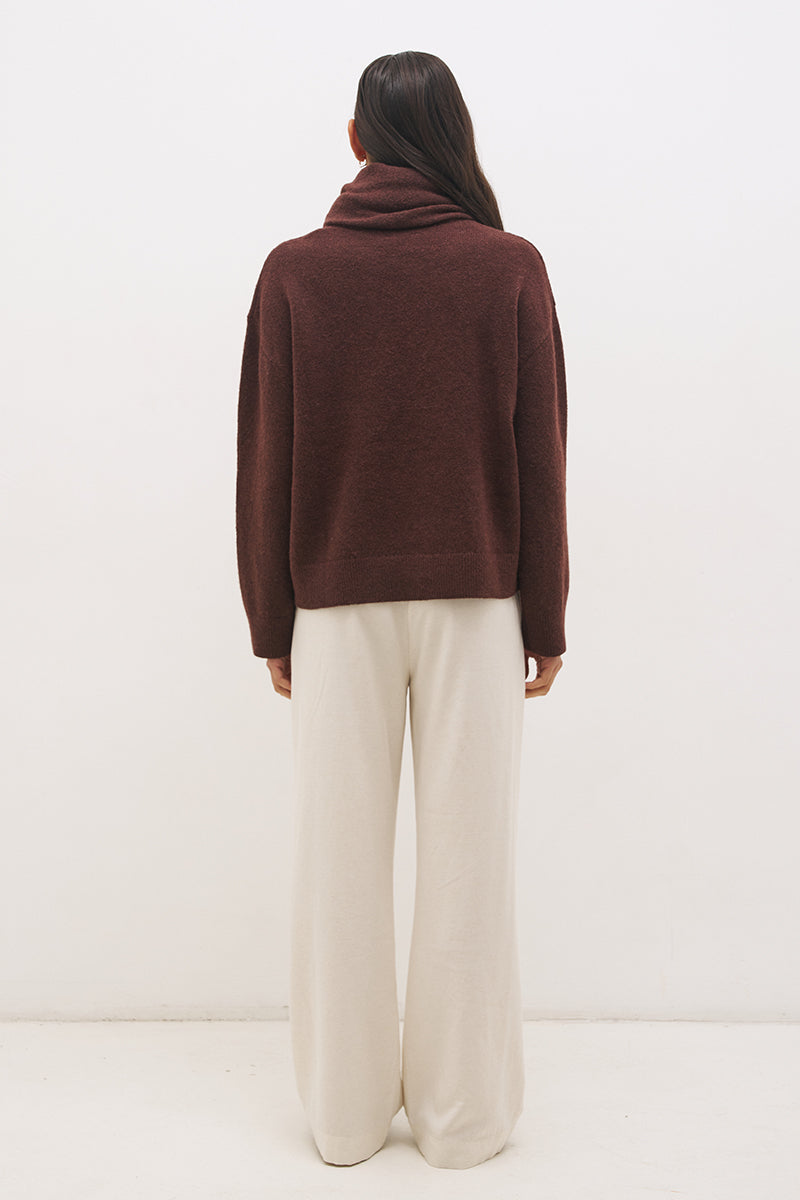 Woman wearing oversized scarf knit jumper with removable tassel scarf, crew neckline, ribbed trims, and relaxed silhouette
