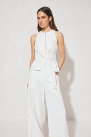 Sleeveless textured woven top with crew neckline, ladder trim detail, twisted waist sash, and side seam splits