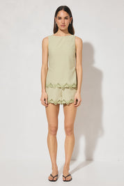 High-waisted tailored shorts with scalloped embroidery, front slant pockets, elasticated back waist, and front zipper closure