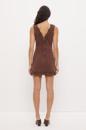 Sleeveless denim mini dress with V-neckline and scallop lace trim detail