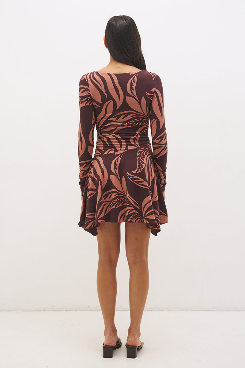 Printed handkerchief hem mini dress with boat neckline, ruched long sleeves, gathered bodice, and hi-lo draped skirt in stretch modal jersey