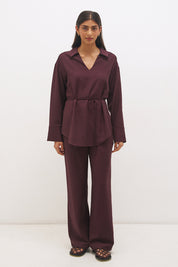 Woman wearing satin-backed linen blend wide leg pants with high-rise fit, scarf waist tie, elasticated back waistband, and relaxed tailored silhouette