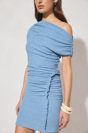 One-shoulder textured jersey mini dress with skimming fit, multi-wear draped neckline, gathered capped sleeve, cascading gathers, contrast frill hip panel, and figure-hugging mini skirt