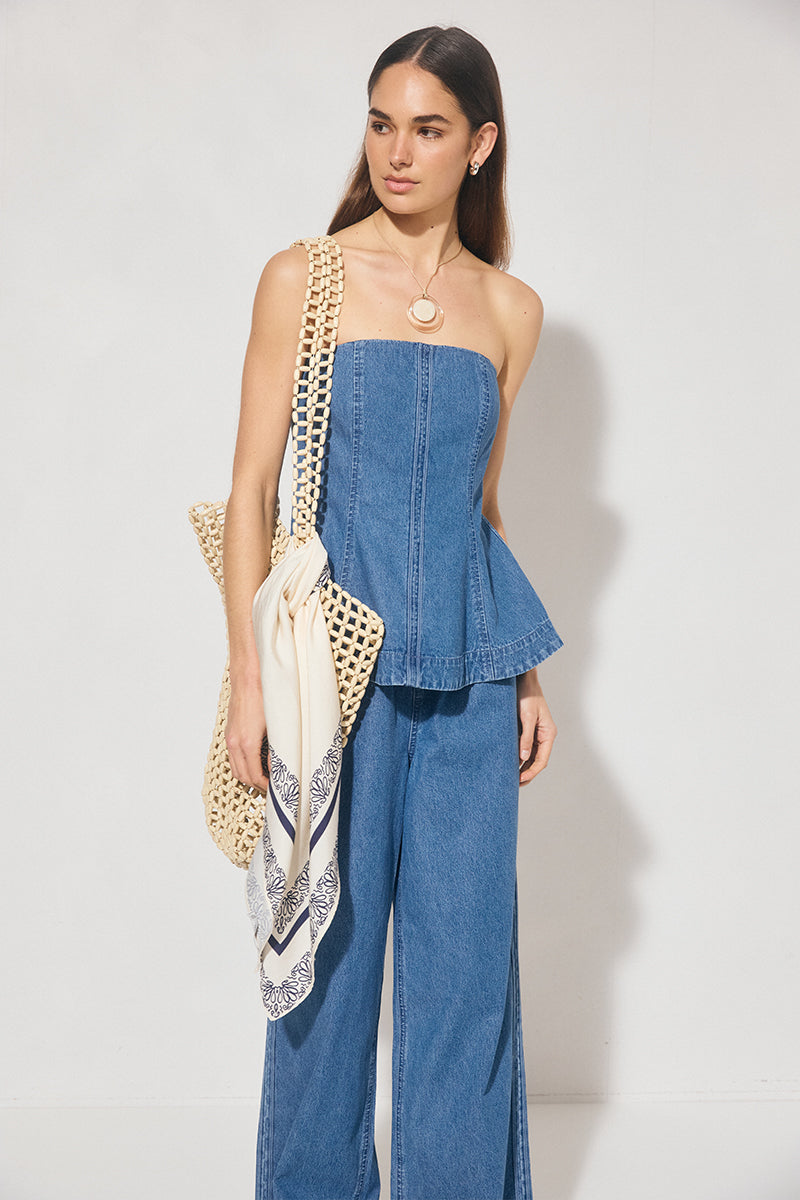 Strapless denim fit-and-flare top with cornelli piping, princess seams, flared circle-cut hem, and centre-back zipper