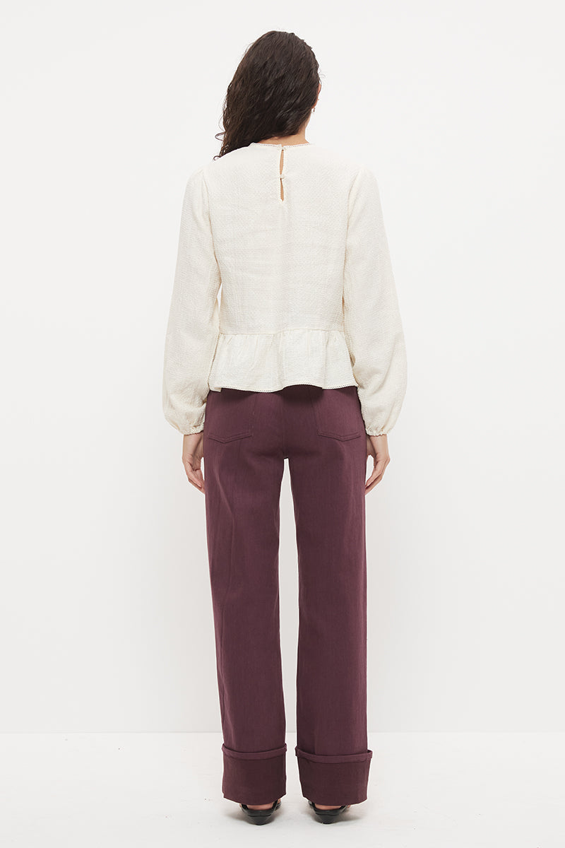 Long sleeve seersucker blouse with scalloped round neckline, balloon sleeves and lace-trimmed peplum hem