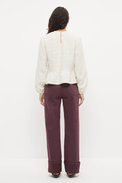 Long sleeve seersucker blouse with scalloped round neckline, balloon sleeves and lace-trimmed peplum hem