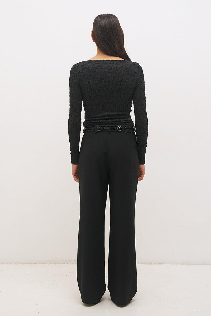 Woman wearing a textured lace long sleeve top with a boat neckline, semi-sheer sleeves, and centre front chest ruching in a skimming fit.