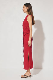 Sleeveless midi dress in textured jersey with skimming column silhouette, boat neckline, waist gathering, contrast frill panel detailing, and side seam split